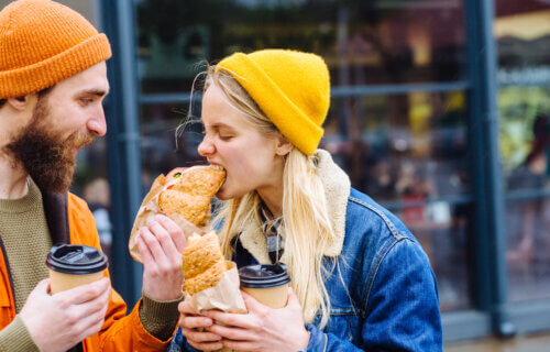 man feeding blond hungry woman in cold weather