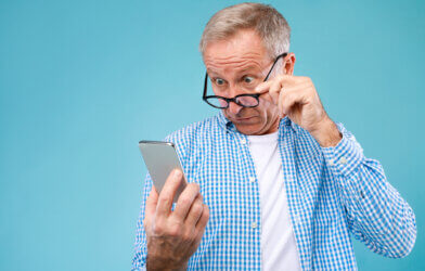Surprised and Confused Adult Man Looking At Smartphone