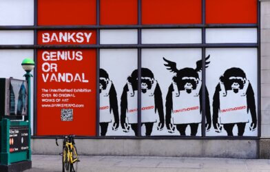 The "Banksy: Genius or Vandal" New York Exhibition displayed many original satirical works of the mysterious England-based street artist and political activist.