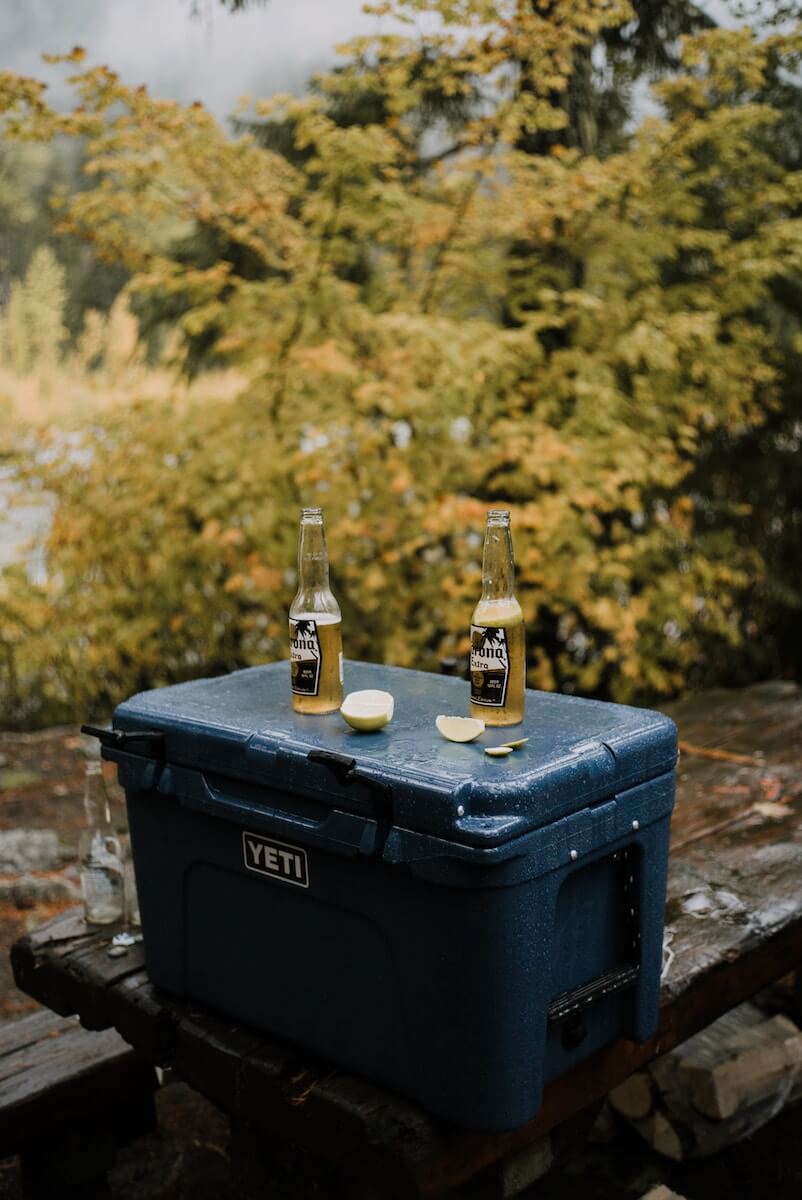 A Yeti cooler with beer on top of it 