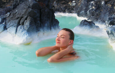A woman in the Blue Lagoon hot springs in Iceland