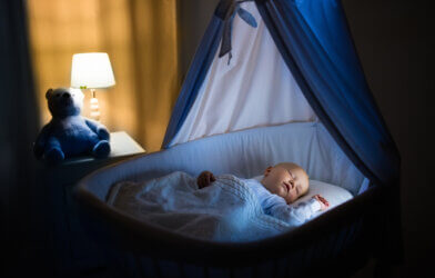 A baby sleeping in a bassinet