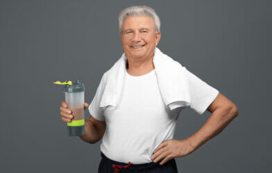 A senior man with a protein shake