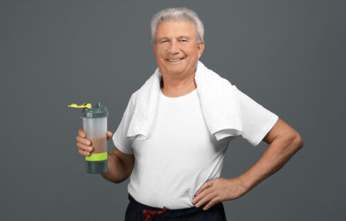 A senior man with a protein shake