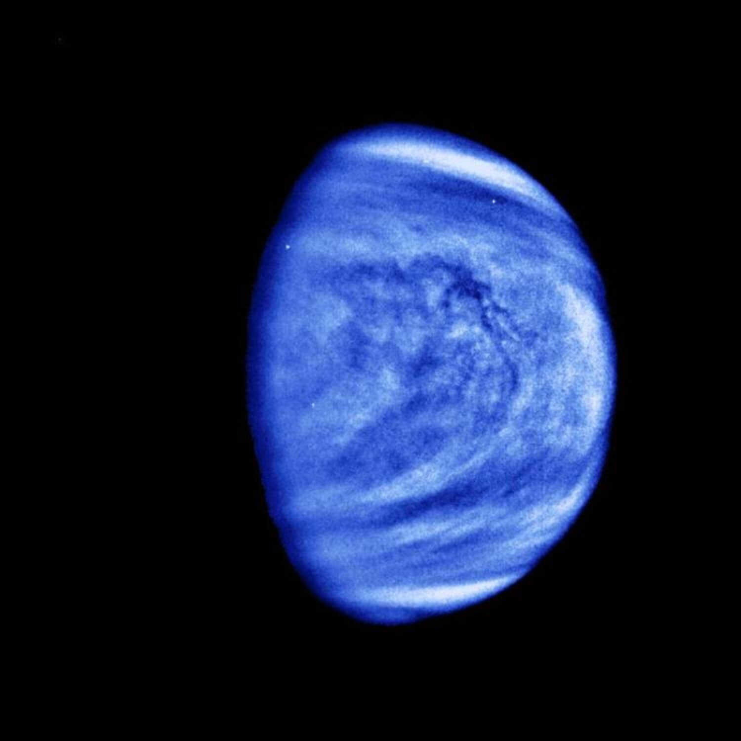 An image of Venus taken by NASA's Galileo spacecraft in 1990, shown in false color to highlight the sulfuric acid clouds swirling above the planet's surface