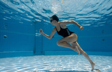 woman running underwater.
