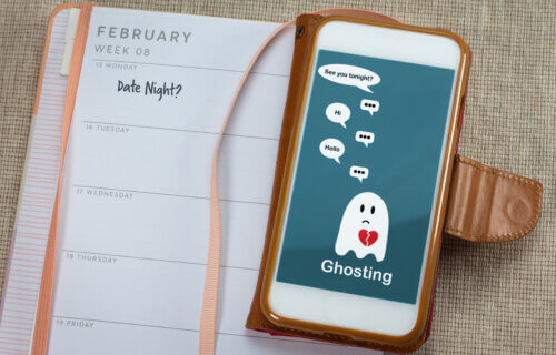 Ghosting on mobile phone on table with diary