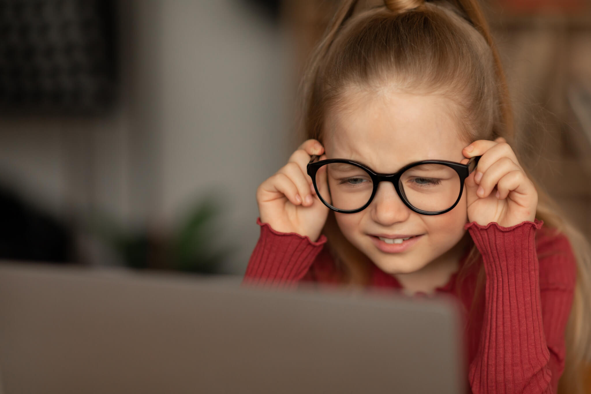 Little Girl Squinting Eyes Using Laptop Wearing Glasses Having Poor Eyesight