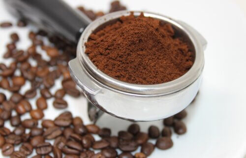 Scoop of coffee grounds and beans