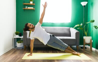 Man performing a side plank at home.