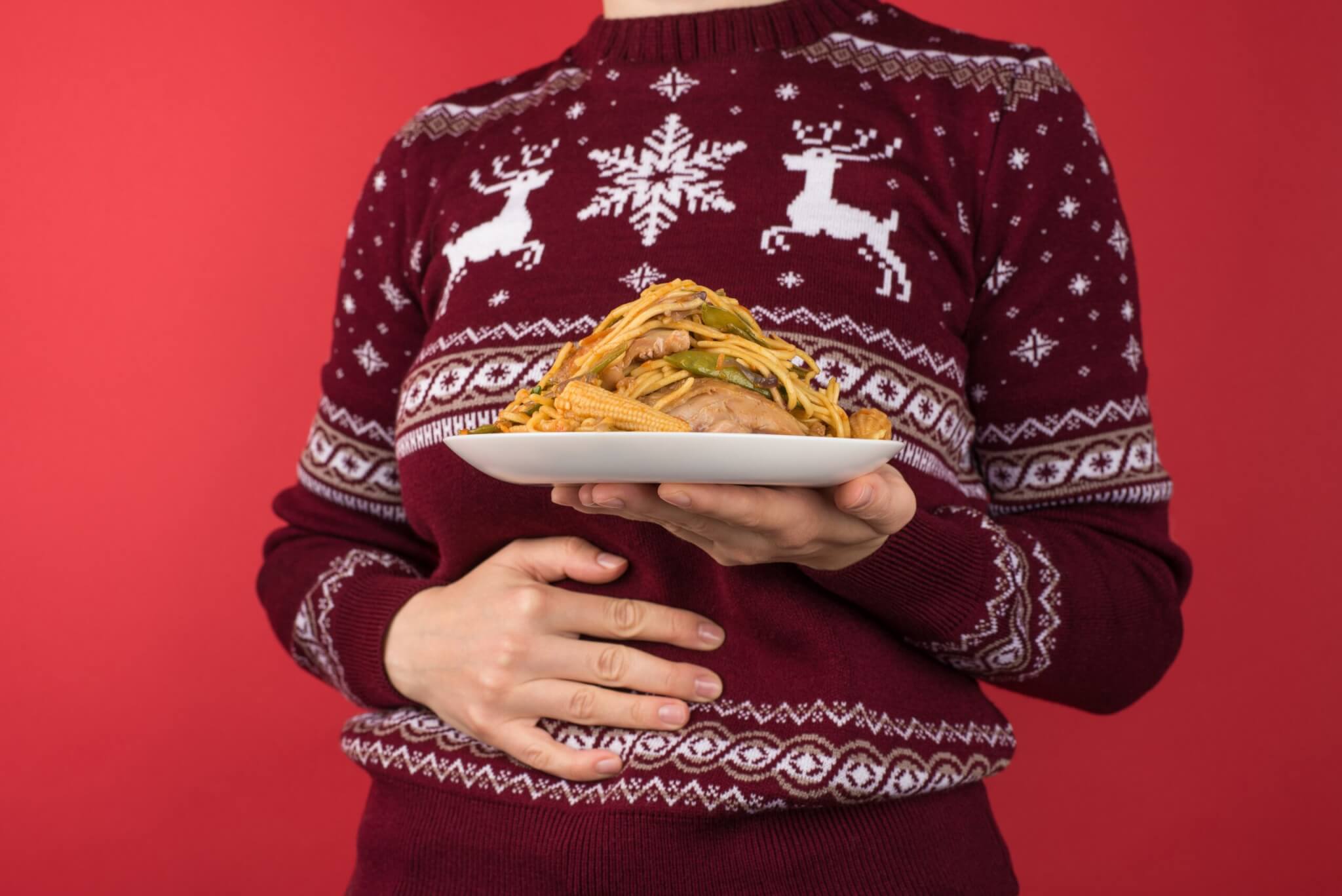 Thanksgiving holiday overeating person holding their stomach
