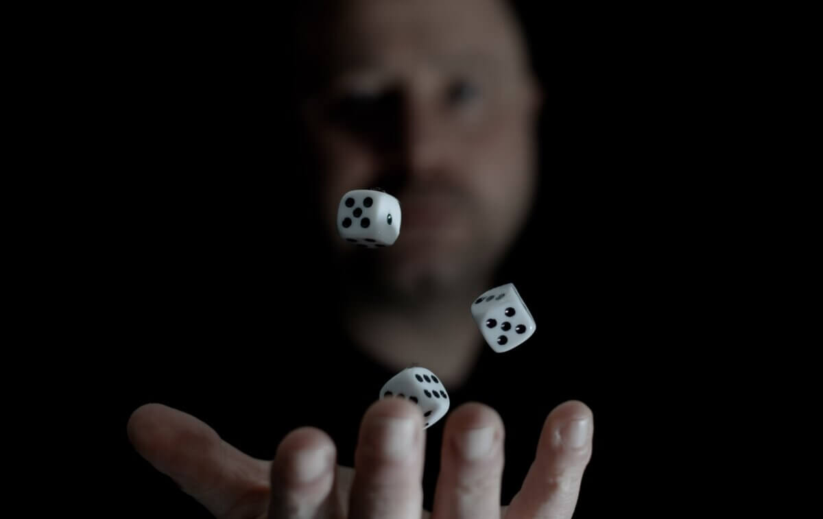 man holding dice in hand