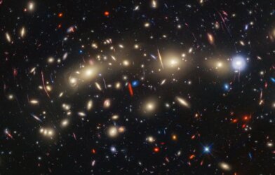 This panchromatic view of galaxy cluster MACS0416 was created by combining infrared observations from NASA’s James Webb Space Telescope with visible-light data from NASA’s Hubble Space Telescope
