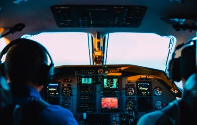 two men sitting in airplane cockpit