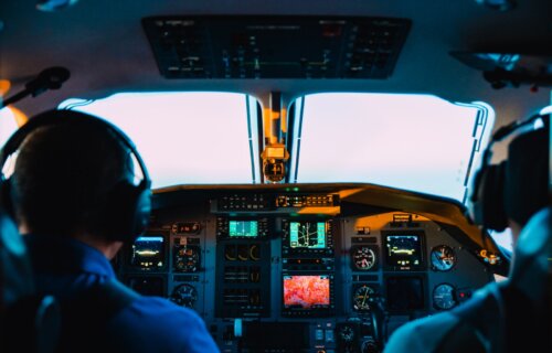 two men sitting in airplane cockpit