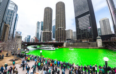 Spectators along the green Chicago River to watch the St. Patrick's Day Parade