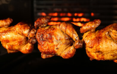 Chickens roasting in a rotisserie oven