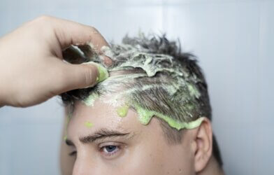 A man using a scalp scrub
