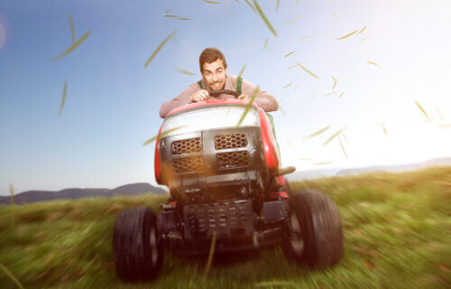 A man on a riding lawn mower