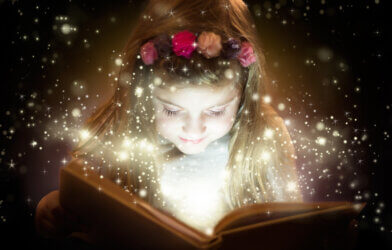 A little girl reading a fairy tale book