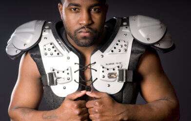 An athlete wearing football shoulder pads