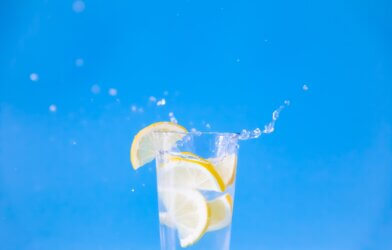 drinking glass with water and lemons