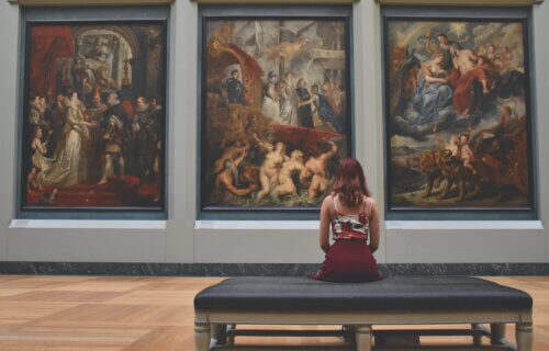Woman looking at paintings at an art museum.