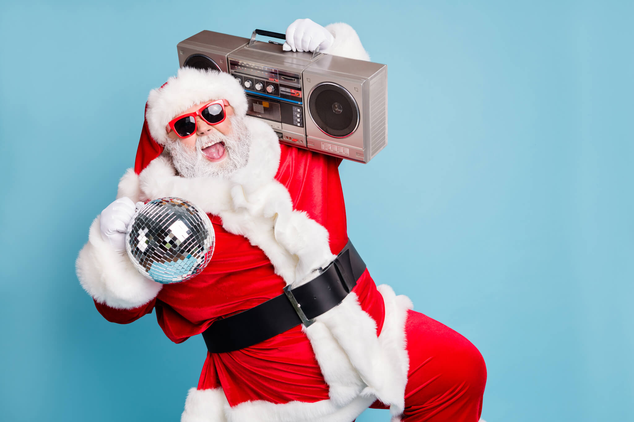 Santa carrying a tape player and dancing