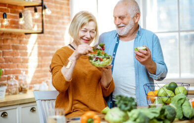 Older couple eating healthy diet with vegetables