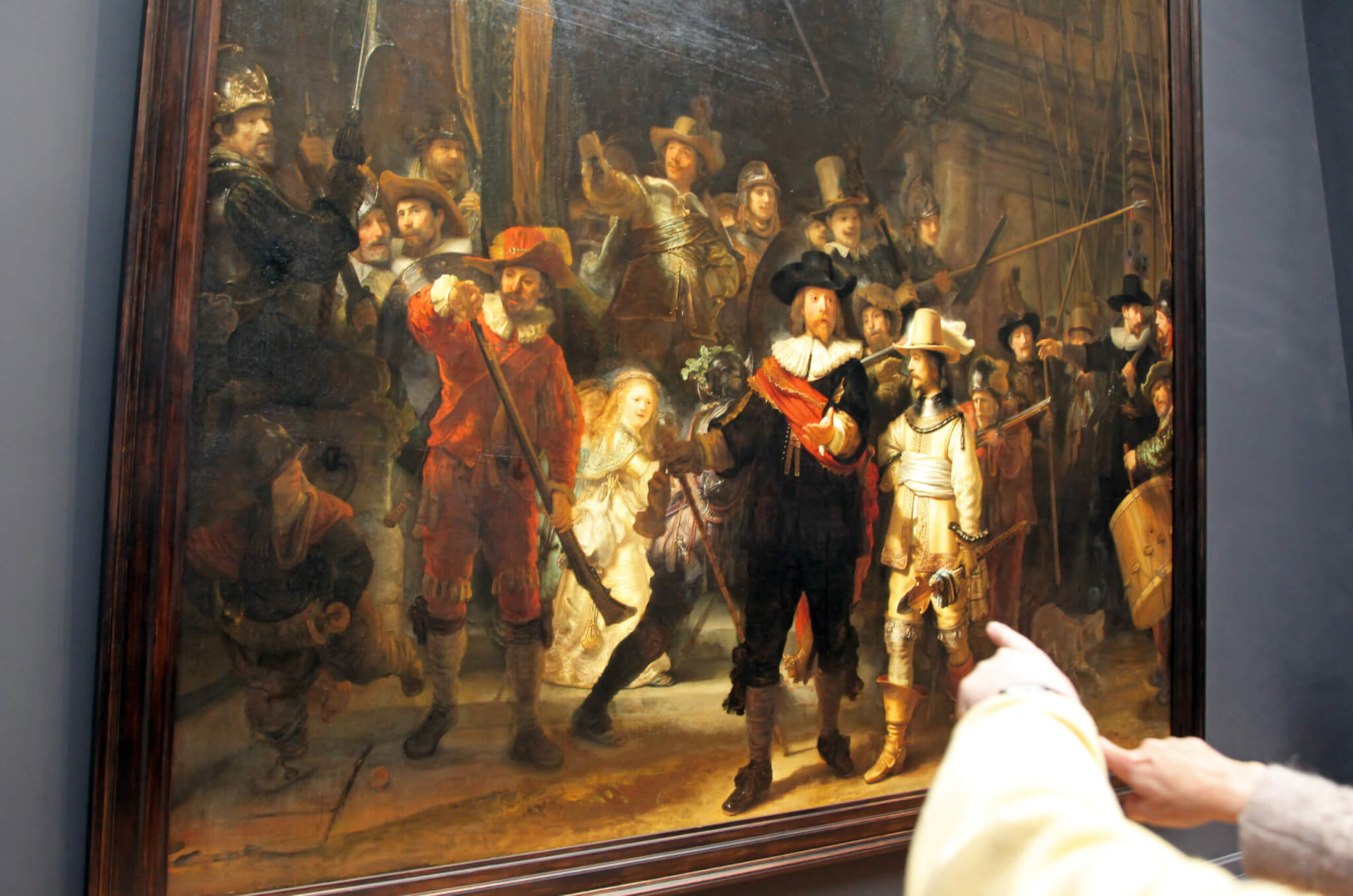 Spectators looking at Rembrandt's "The Night Watch" painting in Rijksmuseum in city Amsterdam. 