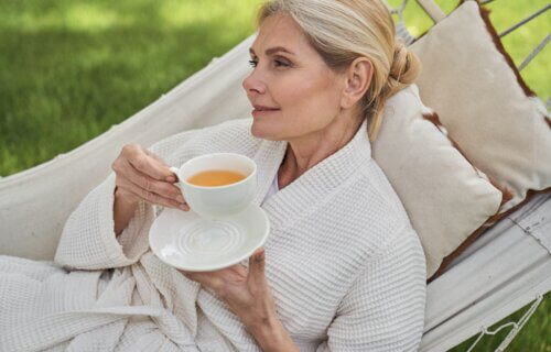 Woman drinking tea on hammock