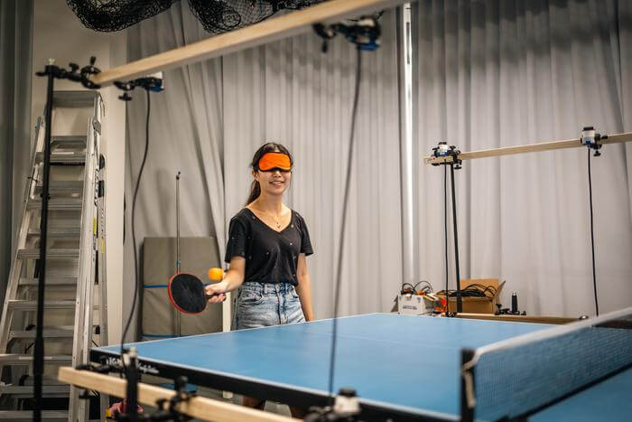 Motion tracking cameras and an array of linked speakers give real-time audio feedback to table tennis players with low vision.