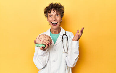 Surprised doctor holding a brain model