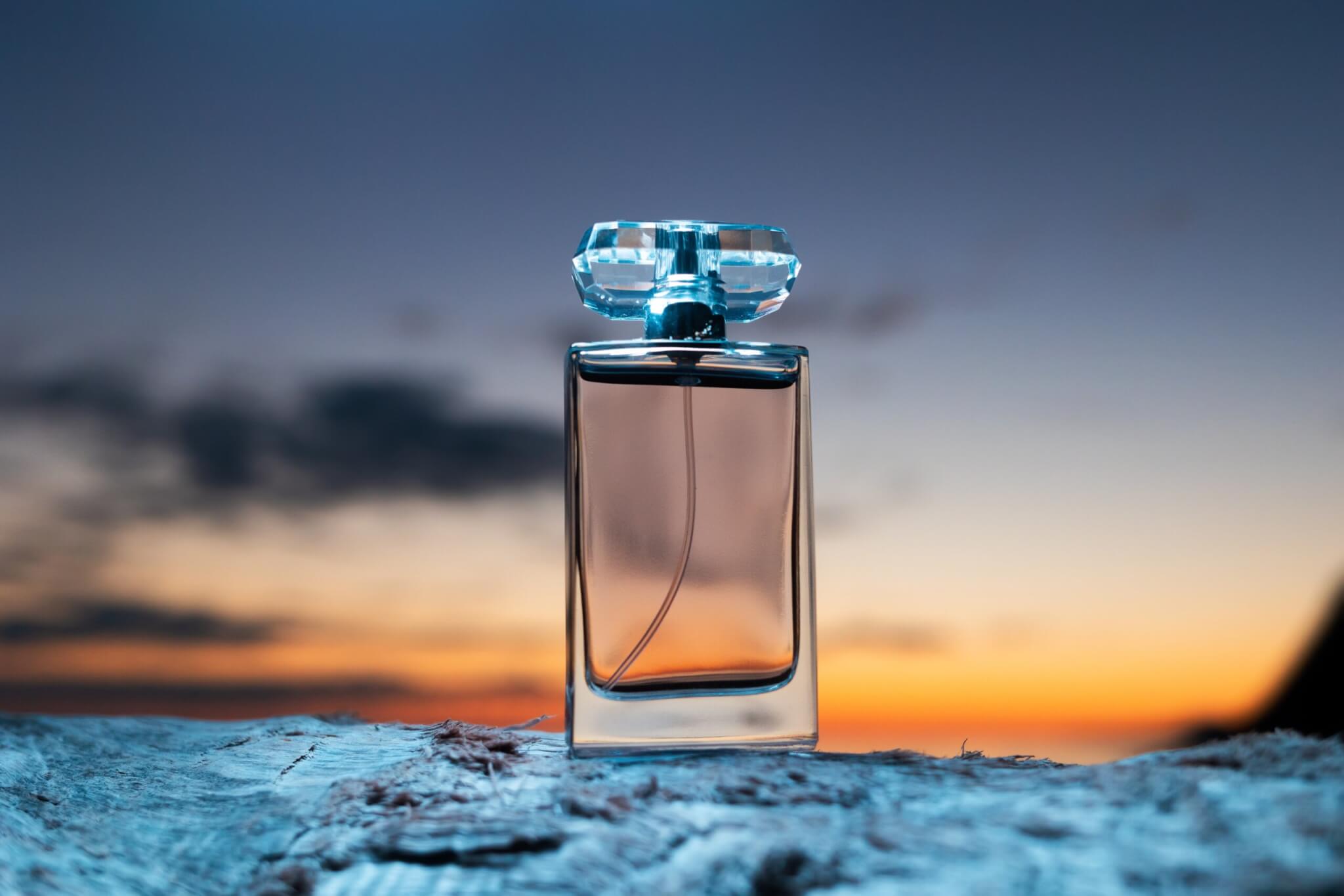 Perfume bottle in front of a sunset