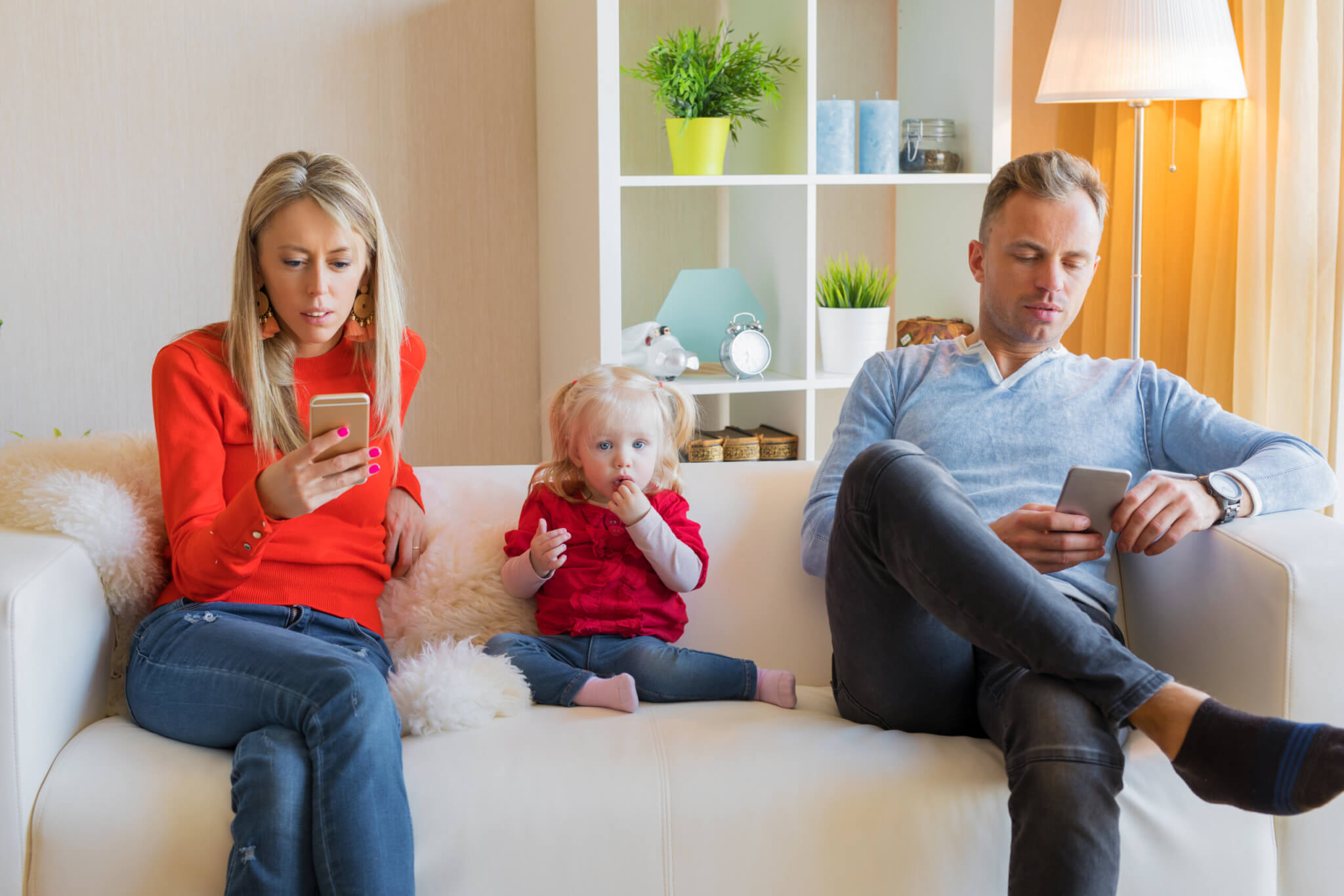 Parents on smartphones ignoring their child