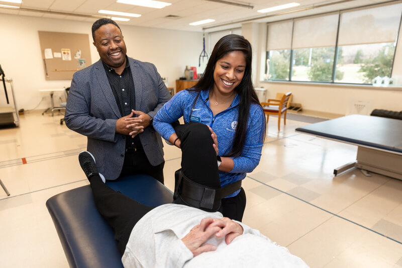 Greg Hicks, professor of physical therapy and associate AVP for clinical and translational research, works on a patient with low back pain, along with Natasha Lobo, a physical therapist in the UD PT Clinic