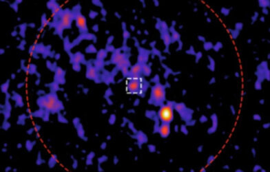 The team identified a new radio source (white square) in the center of the cluster (red circle).