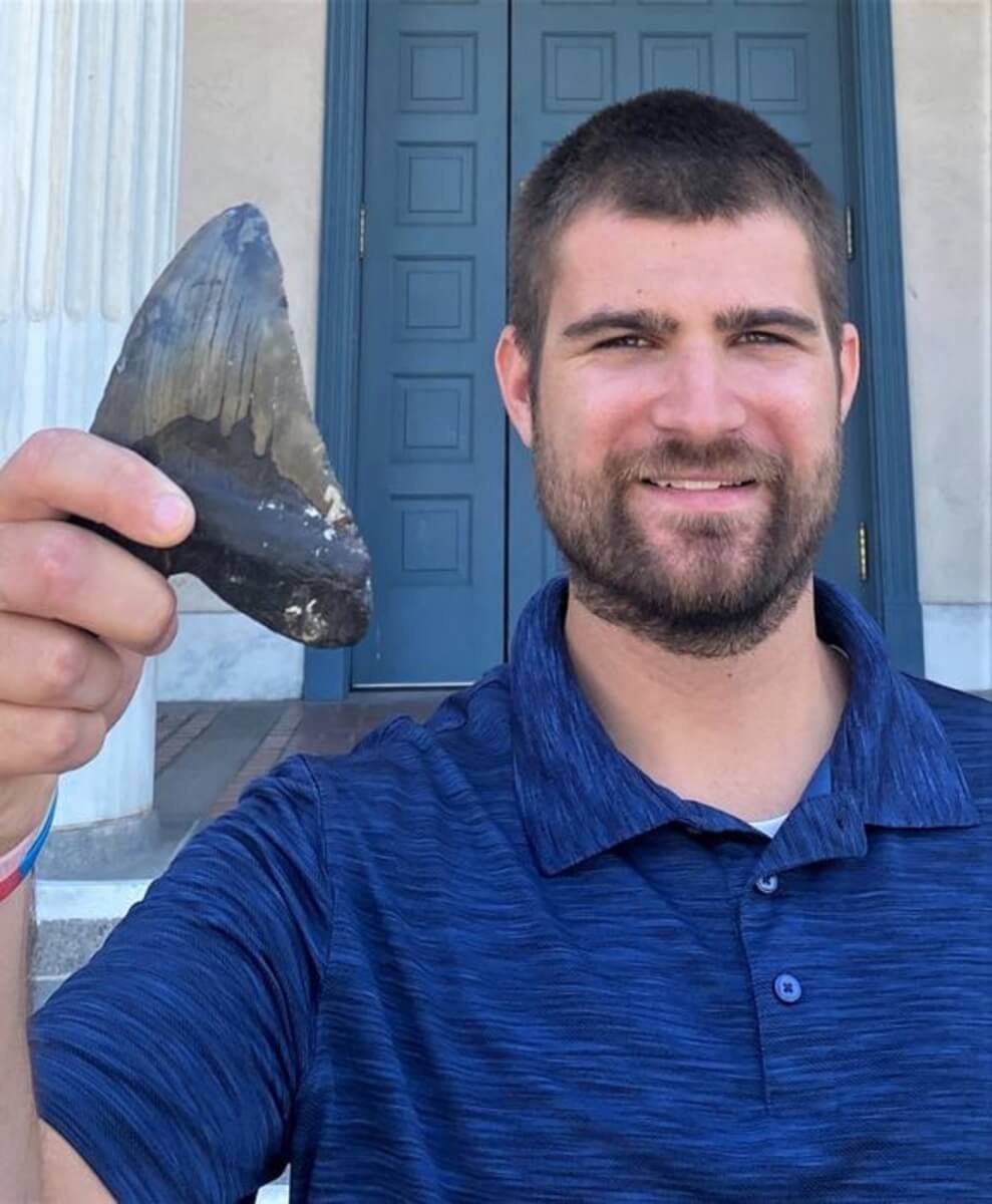 UC Riverside biologist and paper first author Phillip Sternes holding a Megalodon tooth
