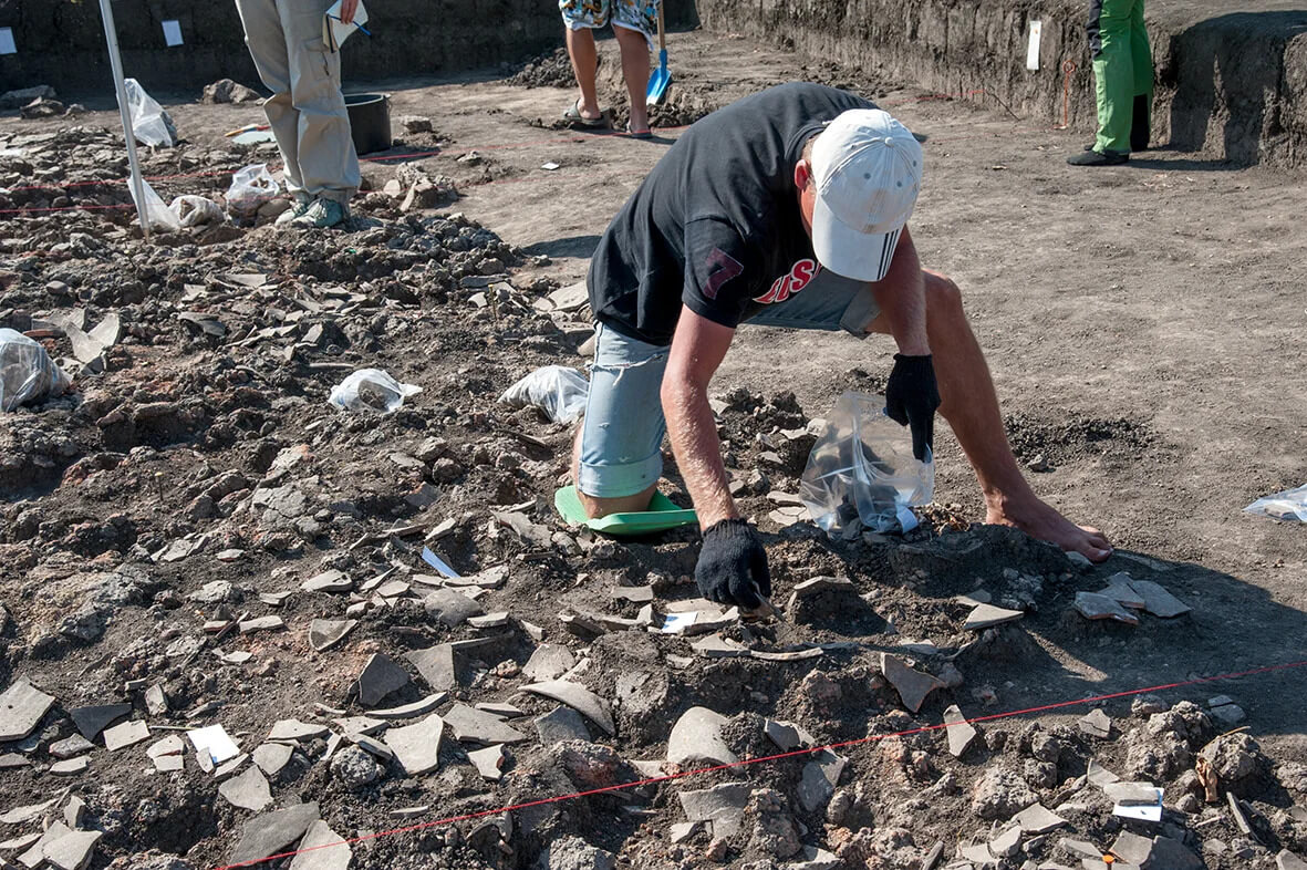 During the archaeological excavation of the Trypillia settlement of Stolniceni located in the northwest of Moldova, restorer Stanislav Fedorov recovers ceramic vessels from the remains of a house that burned down in the 4th millennium BCE