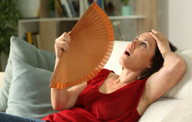A woman experiencing hot flashes due to menopause
