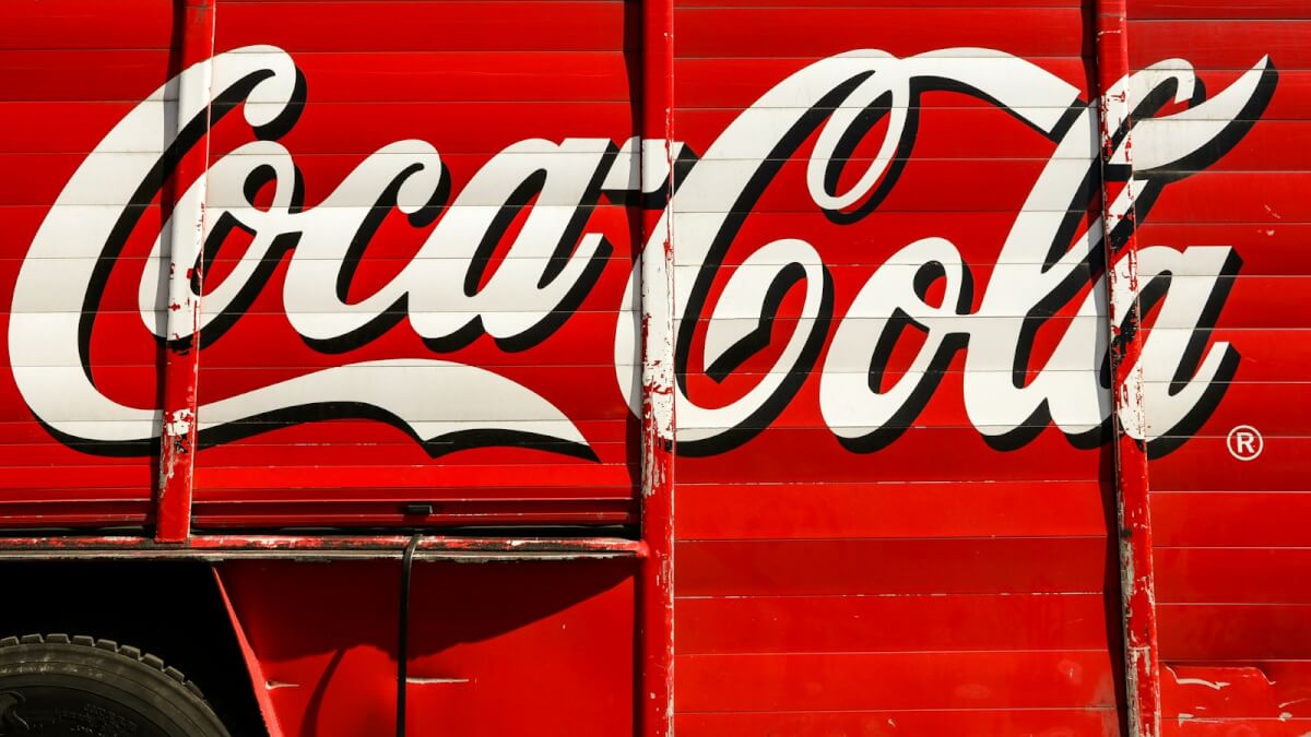 close-up photography of red and white Coca-Cola trailer