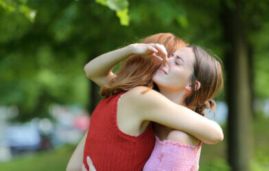 Woman holding her nose because her friend has body odor.