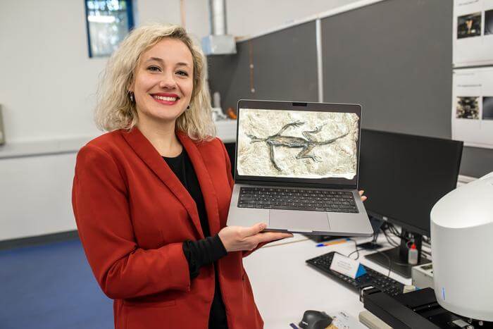 Dr Valentina Rossi with an image of Tridentinosaurus antiquus.