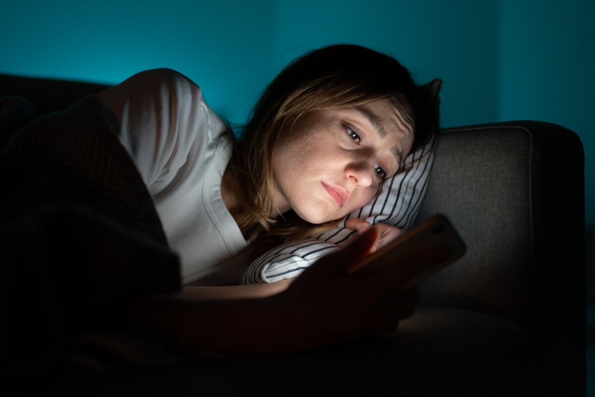 Woman-looking-at-phone-in-bed.jpg