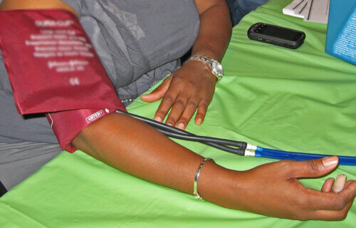 Checking blood pressure using cuff on female