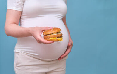 Pregnant woman with burger