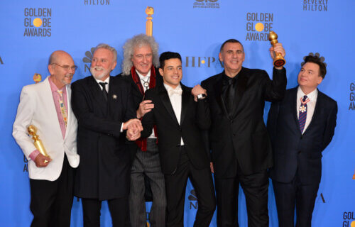 Queen's Jim Beach, Roger Taylor, and Brian May with Rami Malek, Graham King, and Mike Myers at the Golden Globe Awards in 2019