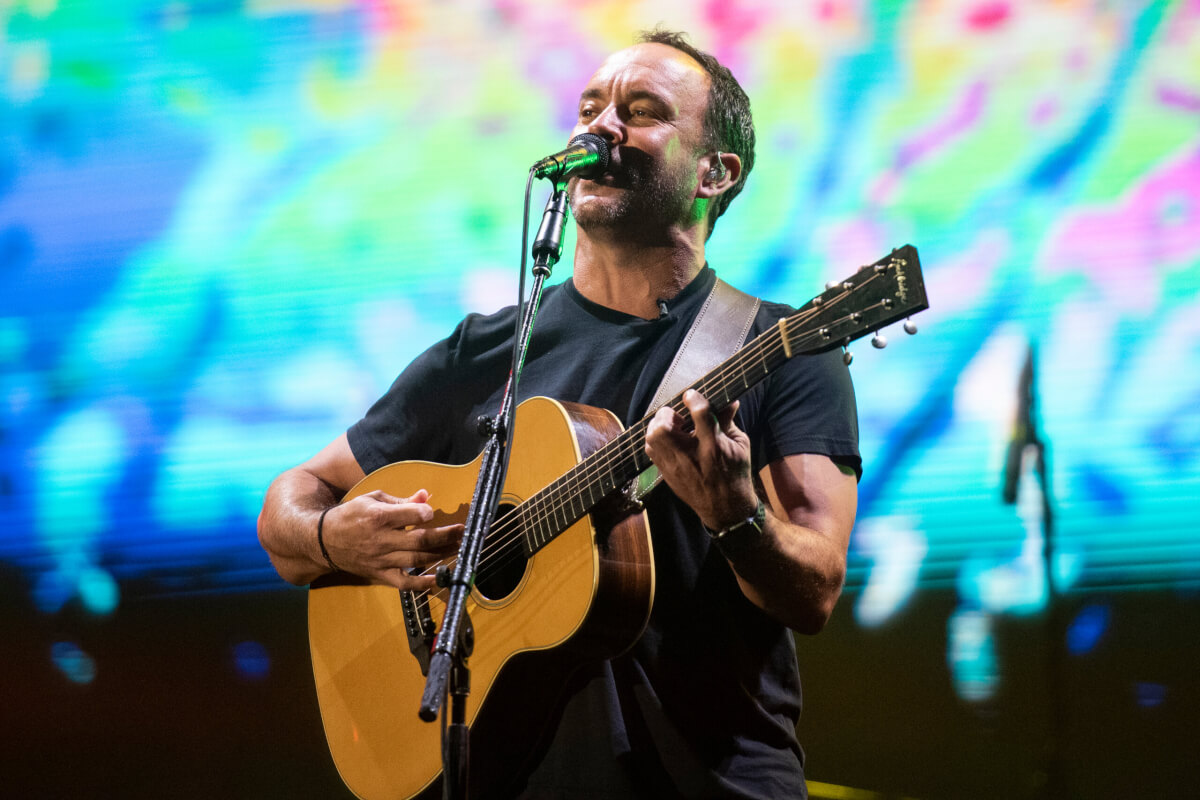 Dave Matthews singing and playing guitar on stage