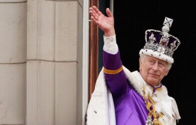 King Charles III waves from Buckingham Palace after coronation on May 06, 2023