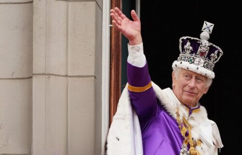 King Charles III waves from Buckingham Palace after coronation on May 06, 2023